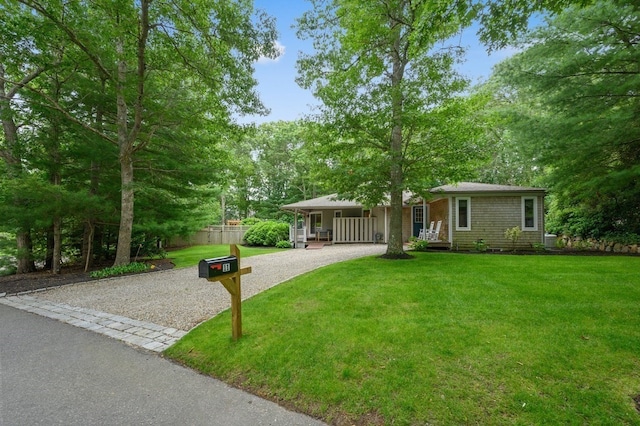 ranch-style house with a porch and a front lawn