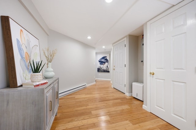 hallway featuring a baseboard heating unit and light hardwood / wood-style floors