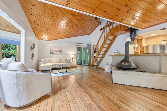 living room featuring a wealth of natural light, light hardwood / wood-style floors, wooden ceiling, and vaulted ceiling