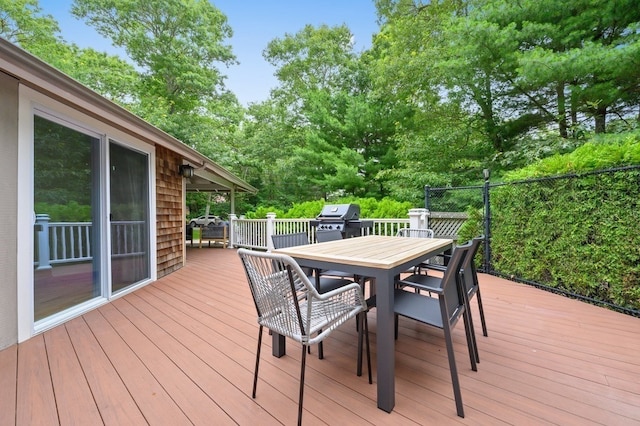 wooden terrace with a grill