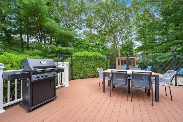 wooden terrace featuring area for grilling