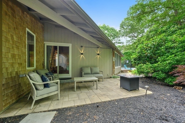 view of patio / terrace featuring an outdoor living space with a fire pit