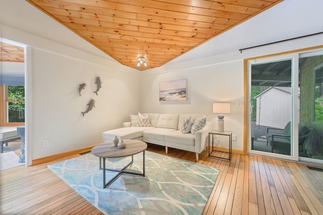 living room with lofted ceiling, plenty of natural light, light wood-type flooring, and wood ceiling