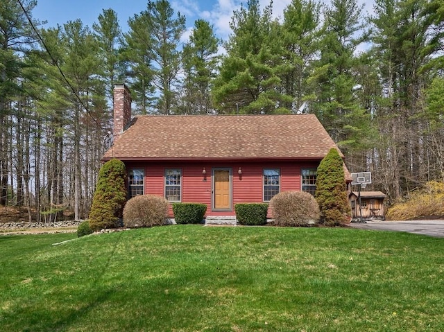 rustic home with a chimney, roof with shingles, and a front lawn