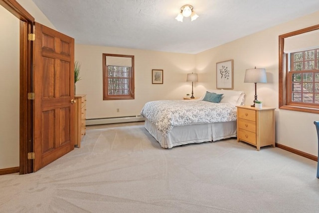 bedroom featuring baseboards, light colored carpet, and baseboard heating