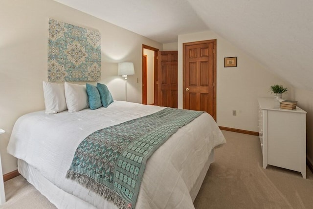 bedroom featuring carpet floors, baseboards, and vaulted ceiling