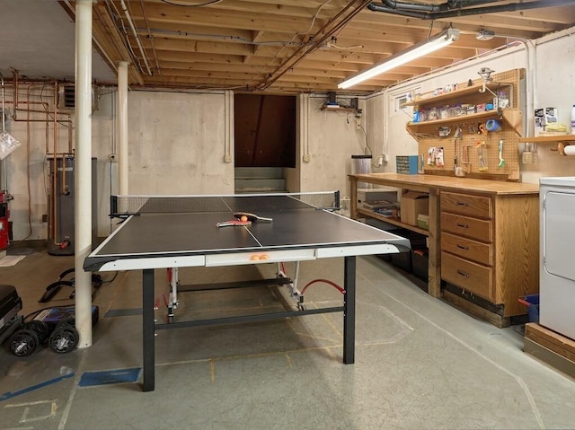 rec room with a workshop area, gas water heater, and concrete floors