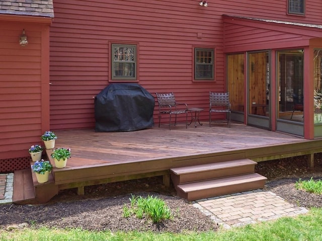 wooden deck with a grill
