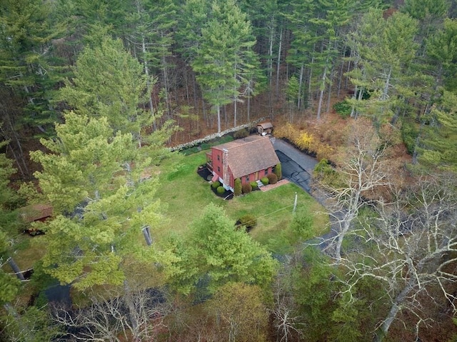 drone / aerial view featuring a wooded view