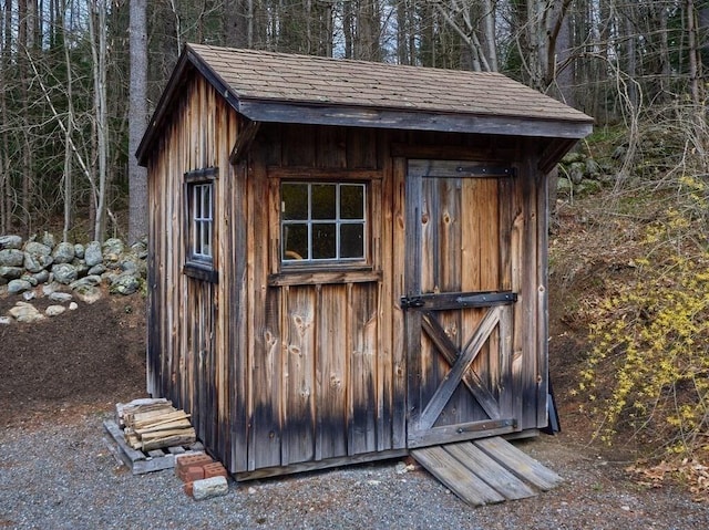view of shed with a wooded view
