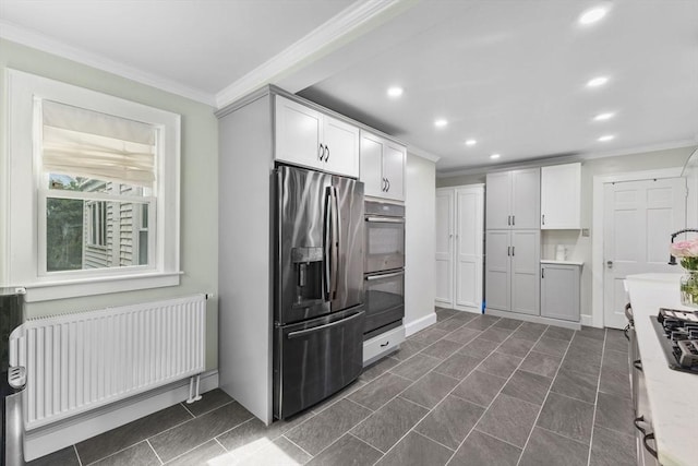 39 Carrlyn Rd, Brockton, MA 02301 - kitchen with appliances with stainless steel finishes, radiator heating unit, ornamental molding, recessed lighting, and white cabinetry