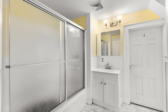 39 Carrlyn Rd, Brockton, MA 02301 - bathroom featuring marble look tiles, vanity, and enclosed tub / shower combo