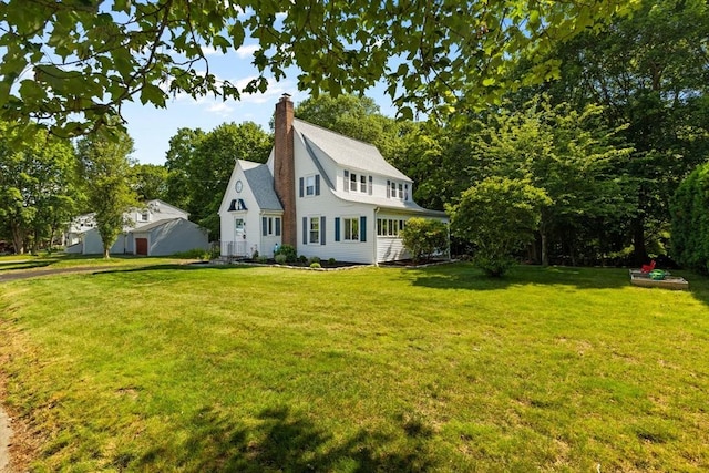 39 Carrlyn Rd, Brockton, MA 02301 - view of front of property with a front yard and a chimney