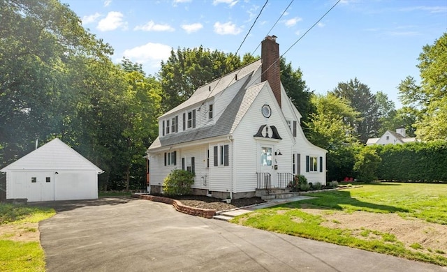 39 Carrlyn Rd, Brockton, MA 02301 - colonial inspired home with an outdoor structure, a front lawn, a chimney, roof with shingles, and a detached garage