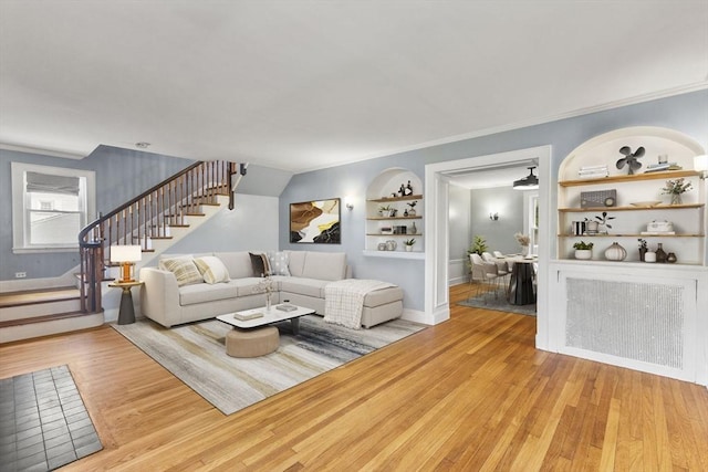 39 Carrlyn Rd, Brockton, MA 02301 - living room with built in features, stairs, light wood-style floors, and crown molding