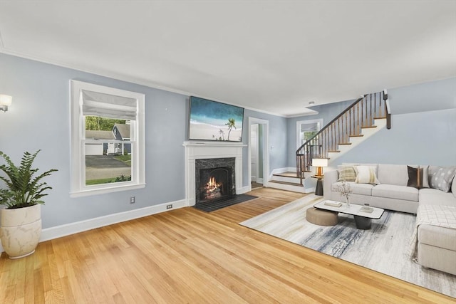 39 Carrlyn Rd, Brockton, MA 02301 - living area with stairway, a high end fireplace, wood finished floors, and crown molding