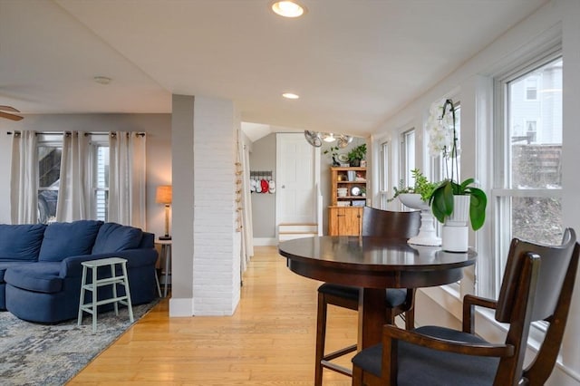 dining space featuring plenty of natural light, light wood-type flooring, and an inviting chandelier