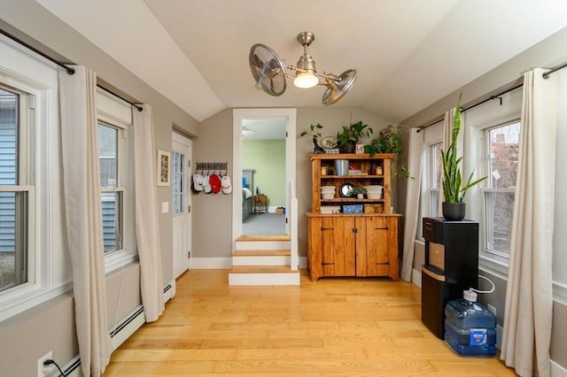 dining area featuring ceiling fan, light hardwood / wood-style flooring, and lofted ceiling