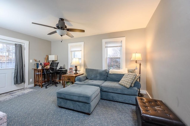 carpeted living room with ceiling fan