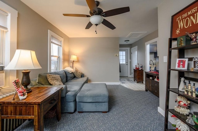 living room featuring ceiling fan and light colored carpet