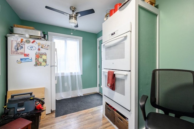 kitchen featuring light wood-type flooring, white appliances, and ceiling fan