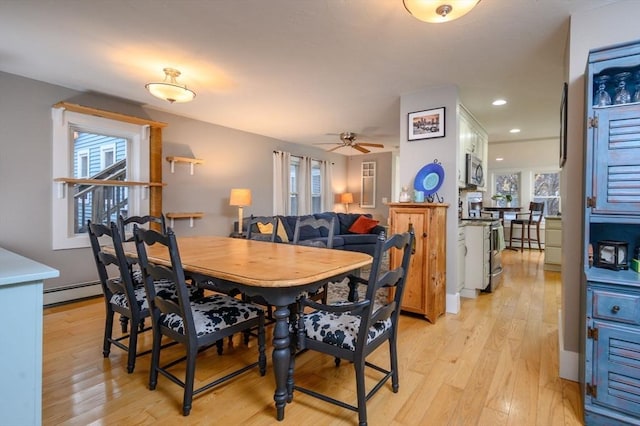 dining space with a baseboard radiator, light hardwood / wood-style flooring, and ceiling fan