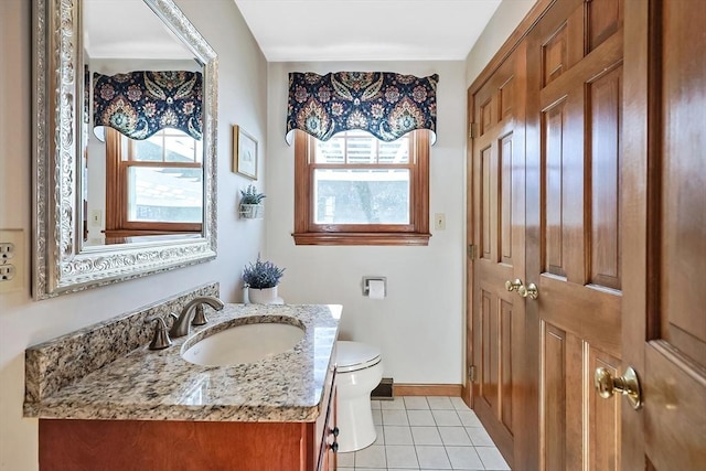 bathroom featuring toilet, tile patterned flooring, baseboards, and vanity