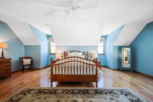 bedroom featuring multiple windows, baseboards, and wood finished floors