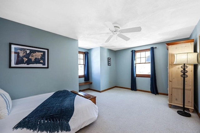 bedroom featuring a ceiling fan, carpet, and baseboards