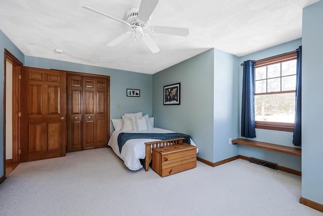 carpeted bedroom featuring visible vents, baseboards, and a ceiling fan