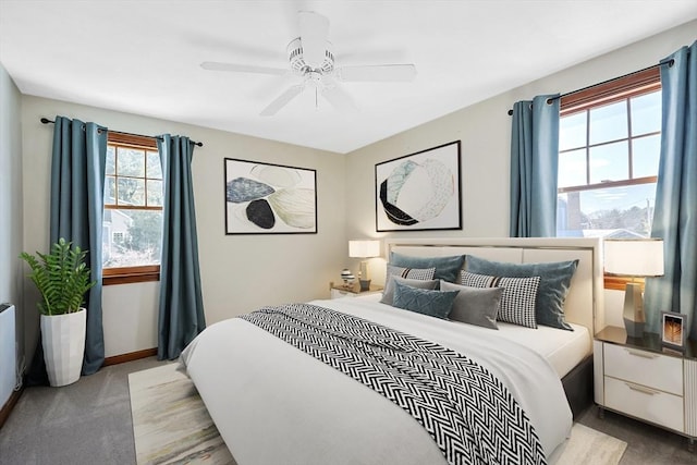 bedroom featuring light carpet, a ceiling fan, and baseboards