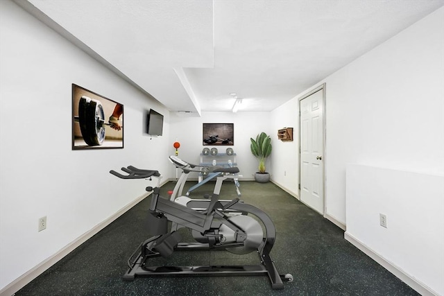 workout room featuring baseboards