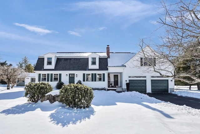 dutch colonial with a garage, a chimney, aphalt driveway, and roof with shingles