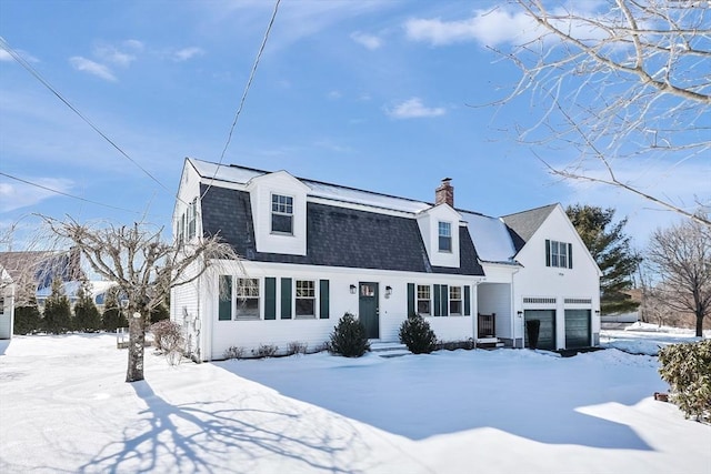 dutch colonial with a shingled roof, a gambrel roof, and an attached garage