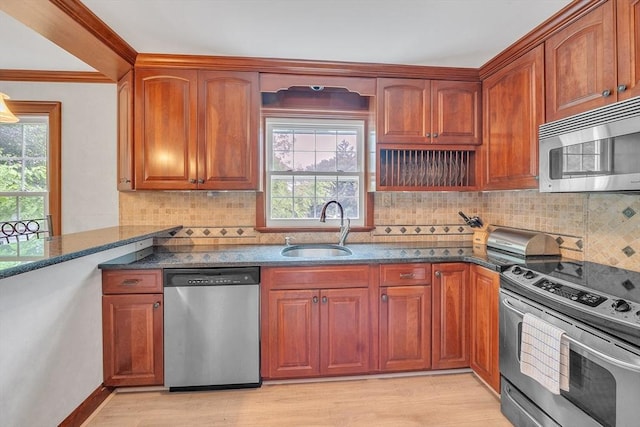 5 Upland St, Auburn, MA 01501 - kitchen with stainless steel appliances, dark stone counters, healthy amount of natural light, backsplash, and crown molding