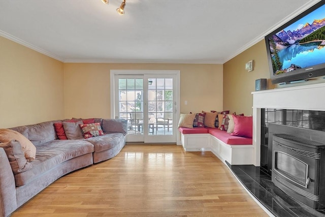 5 Upland St, Auburn, MA 01501 - living area with light wood-style flooring, ornamental molding, and a wood stove