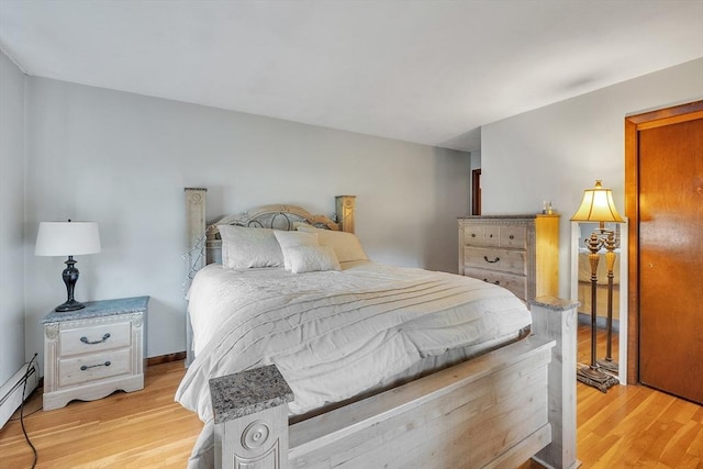 5 Upland St, Auburn, MA 01501 - bedroom featuring a baseboard heating unit and light wood-style flooring