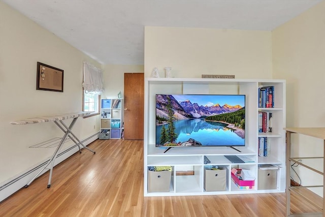 5 Upland St, Auburn, MA 01501 - living area with wood finished floors and a baseboard radiator
