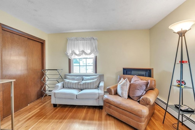 5 Upland St, Auburn, MA 01501 - living area with a baseboard heating unit, wood finished floors, and a baseboard radiator