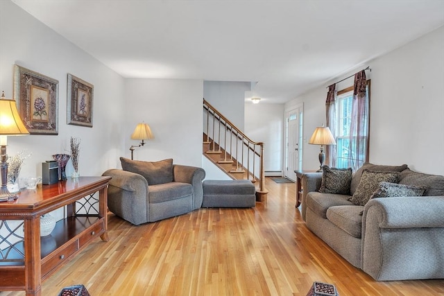 5 Upland St, Auburn, MA 01501 - living room featuring stairs, light wood-style flooring, and a baseboard heating unit