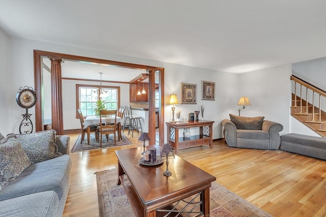 5 Upland St, Auburn, MA 01501 - living room with stairway, light wood finished floors, and ornate columns