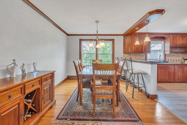 5 Upland St, Auburn, MA 01501 - dining area featuring light wood-style flooring, crown molding, and baseboard heating