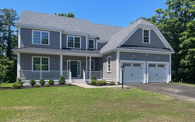 view of front facade with a front lawn, a porch, and a garage