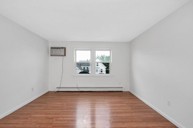 45 W 3rd St Unit 6, Lowell, MA 01850 - empty room with a baseboard radiator, a wall mounted air conditioner, and wood finished floors