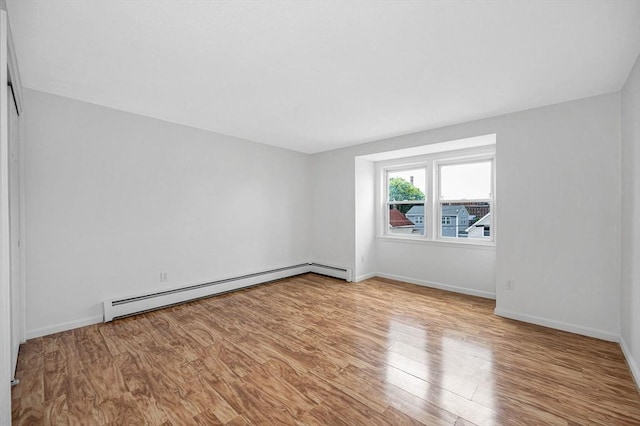 45 W 3rd St Unit 6, Lowell, MA 01850 - empty room with baseboard heating and wood finished floors