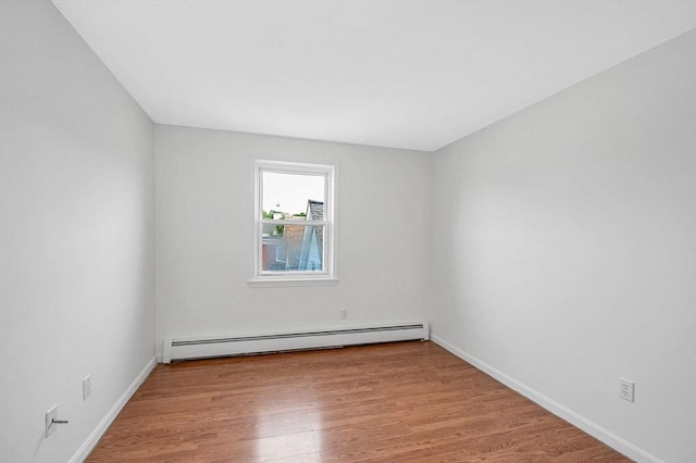 45 W 3rd St Unit 6, Lowell, MA 01850 - empty room featuring a baseboard heating unit and wood finished floors