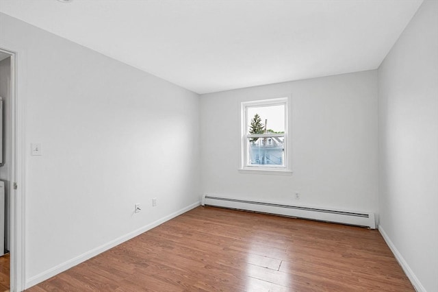 45 W 3rd St Unit 6, Lowell, MA 01850 - empty room with a baseboard heating unit and wood finished floors
