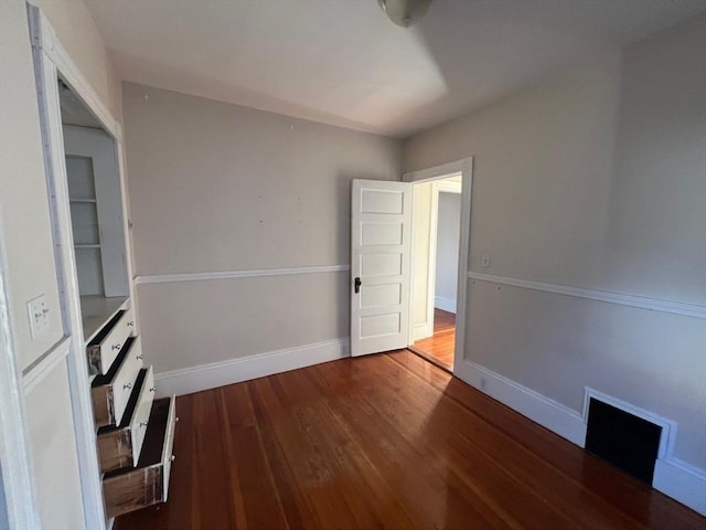 spare room featuring dark hardwood / wood-style flooring