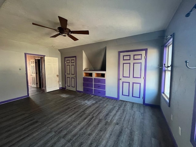 interior space featuring ceiling fan, dark hardwood / wood-style flooring, and a textured ceiling