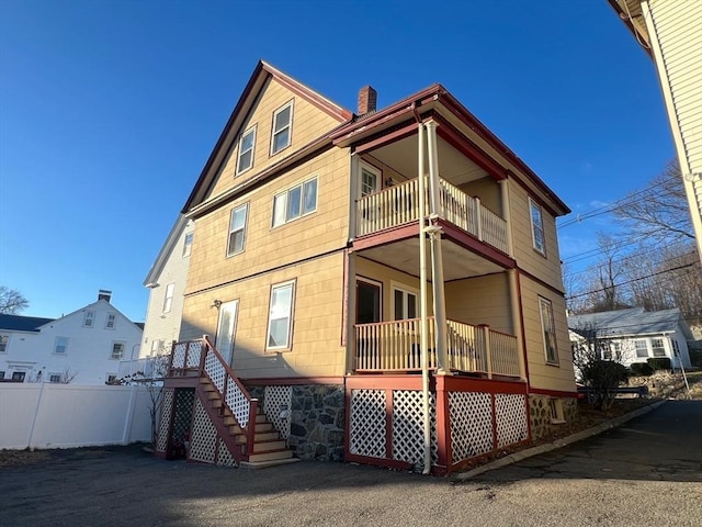 back of house featuring a balcony